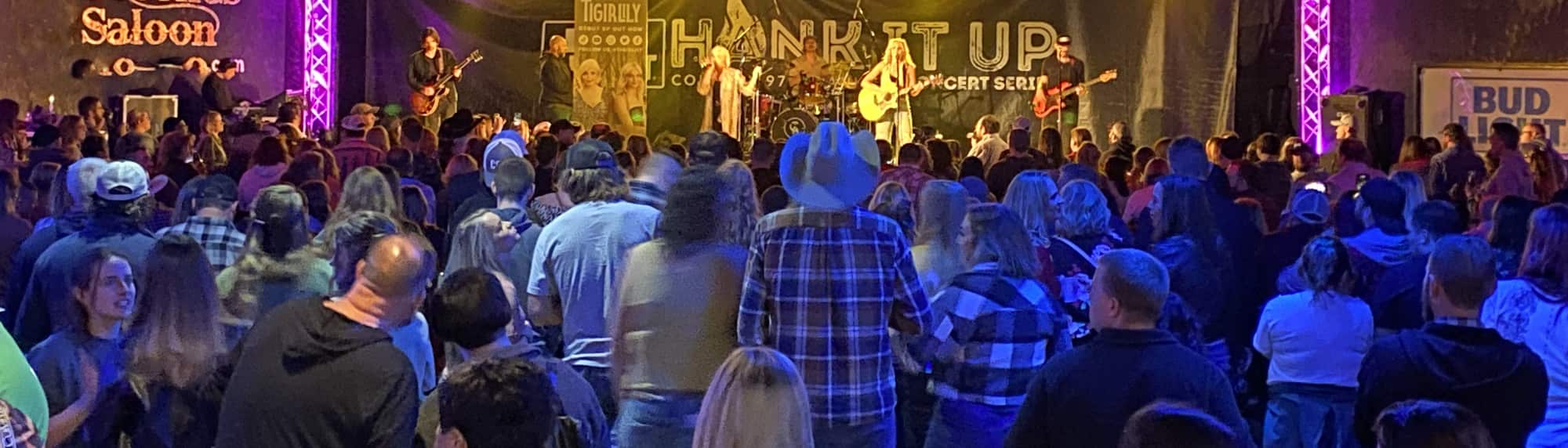 country concert with fans wearing cowboy hats Champaign